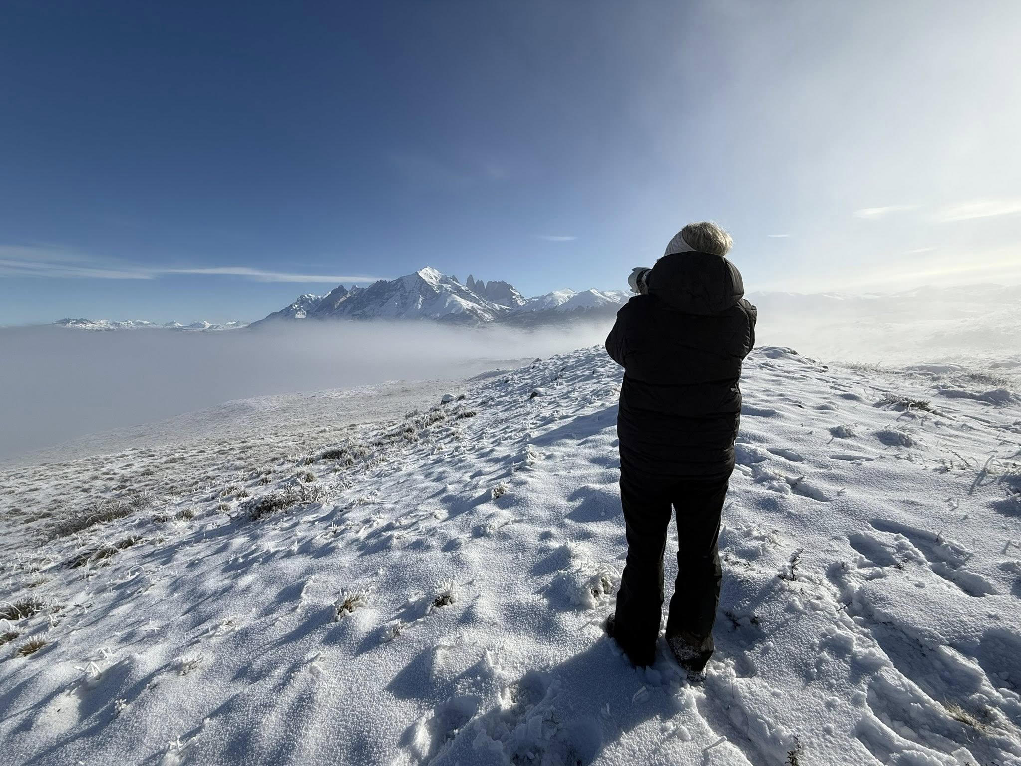 Photograph of a woman capturing wildlife in the mountains, reflecting a life of freedom, reflection, and self-directed living after leaving corporate.